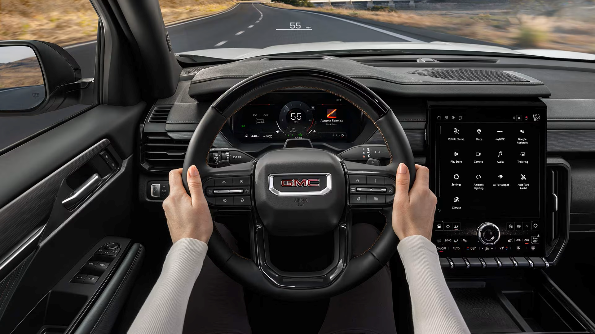 Hands holding a GMC steering wheel, view of safety features
