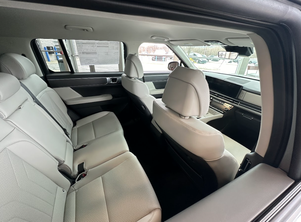 Spacious interior of a Hyundai SUV featuring light-colored leather seats and rear climate vents