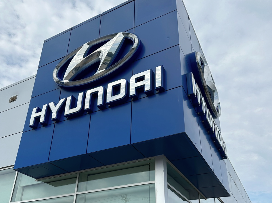 Exterior shot of the Crain Hyundai dealership building in Fayetteville, Arkansas featuring the Hyundai logo on a bold blue panel.