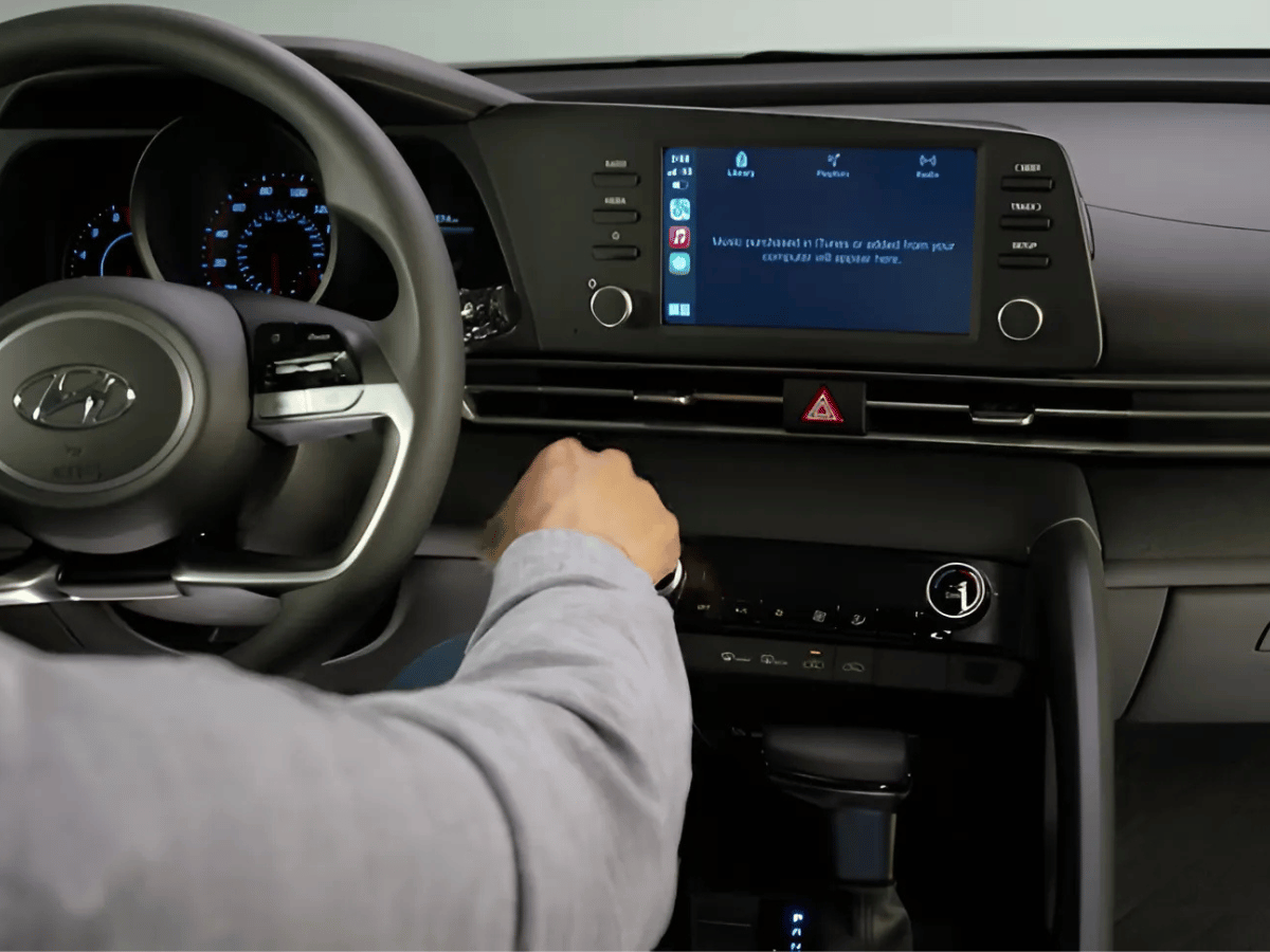 Driver uses infotainment system in the 2025 Hyundai Kona featuring wireless Apple CarPlay connectivity.