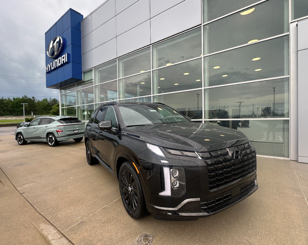 Black Hyundai SUV parked in front of Crain Hyundai of Fayetteville, showcasing advanced safety features