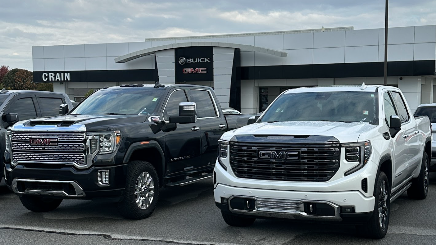 Black and white GMC pickup trucks parked at Crain Buick GMC in Springdale, Arkansas