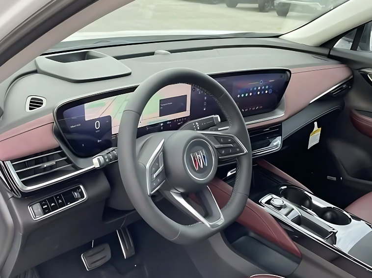 Interior view of the 2025 Buick Envision showing digital driver cluster, infotainment display, and two-tone upholstery