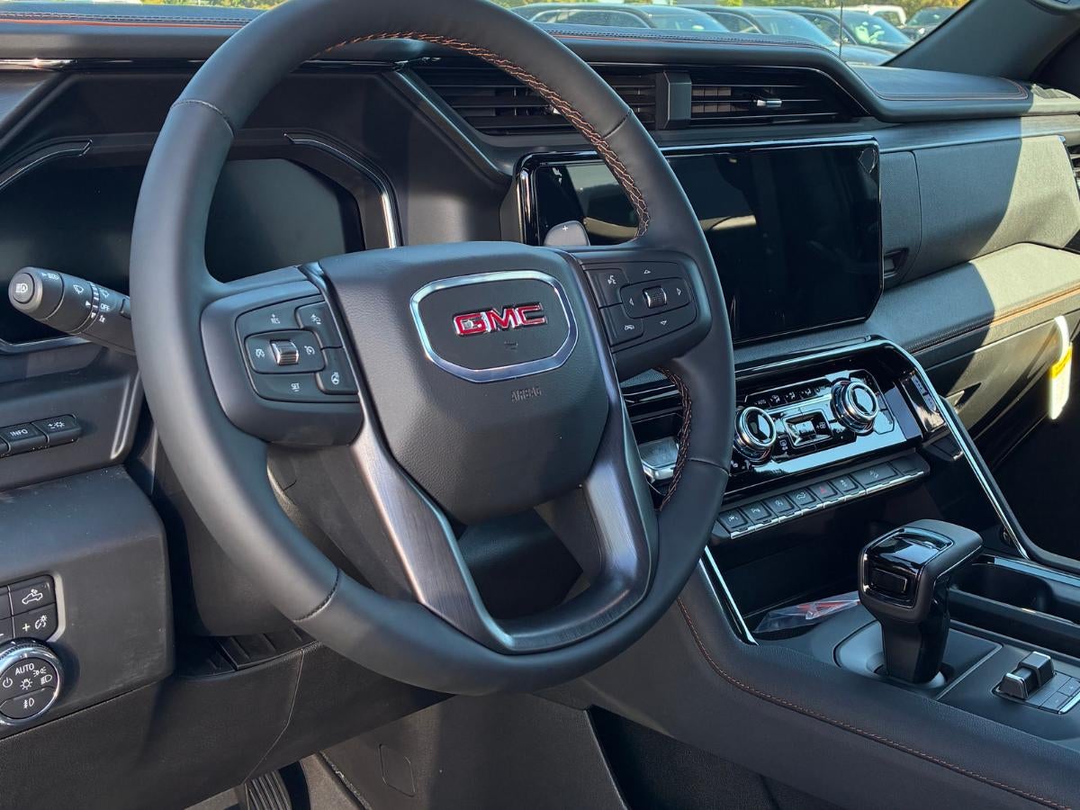 Interior of a GMC vehicle at Crain Buick GMC of Springdale, showing the steering wheel and center display where Google Built-In features can be accessed.