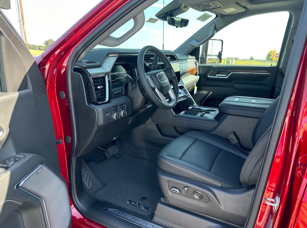 Interior of a red GMC Denali pickup truck with premium black leather and modern dashboard, located at Crain Buick GMC in Springdale, Arkansas