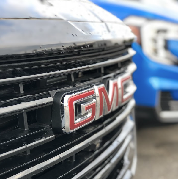 Close-up of a GMC grille with raindrops on the chrome trim
