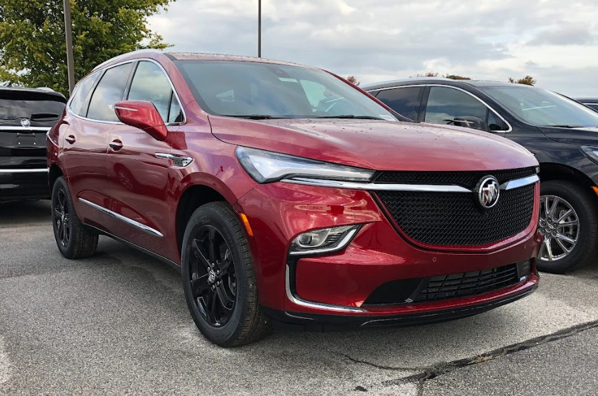 Red Buick SUV parked at Crain Buick GMC in Springdale, Arkansas, surrounded by other new vehicles