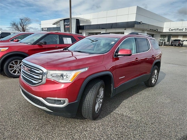 Red GMC Acadia SUV parked outside Crain Buick GMC in Springdale, Arkansas