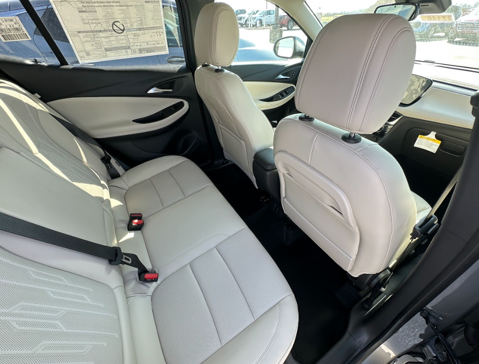 Interior of a Buick SUV showing spacious second-row seating with light-colored upholstery