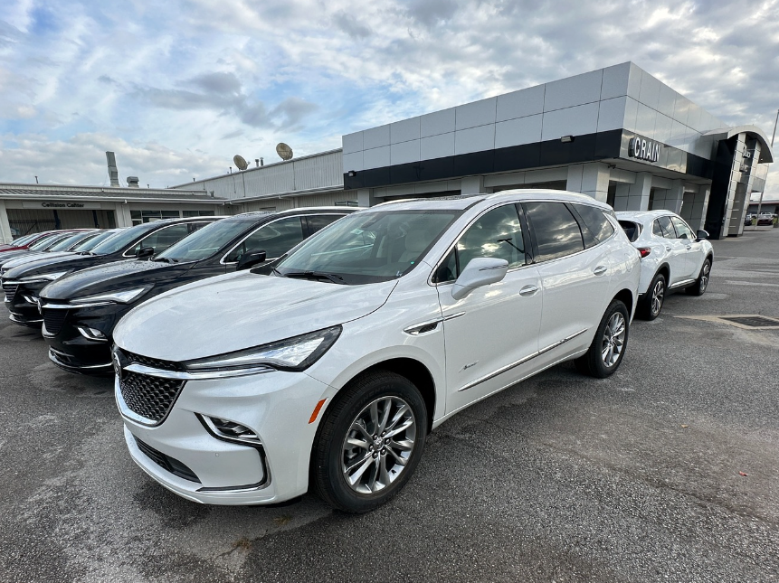 White Buick SUV parked at Crain Buick GMC in Springdale, Arkansas, alongside a row of other vehicles