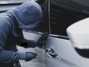 Person breaking into a car in Baltimore, MD