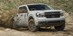 a white 2024 ford maverick driving through mud | Lanham, MD