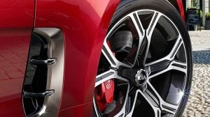 Red Kia Stinger Tire Driving On Road