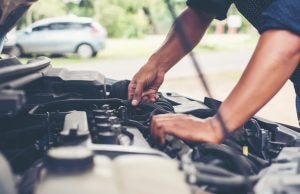 Mechanic Checking Engine and Hoses