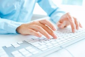 Hands Typing on Keyboard