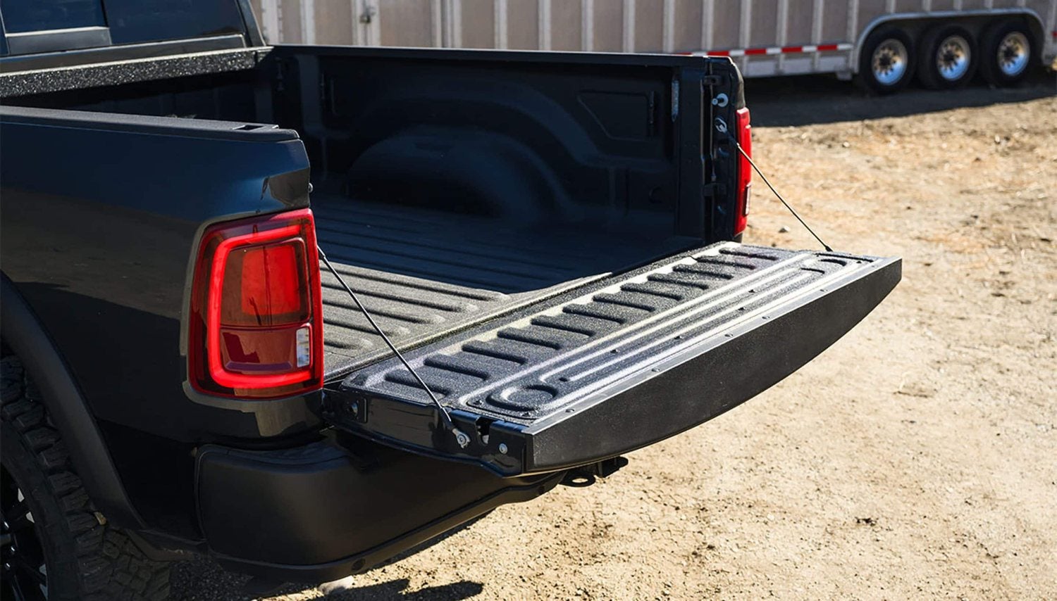 Black 2026 Ram 2500 Rebel 4x4 crew cab with the tailgate open