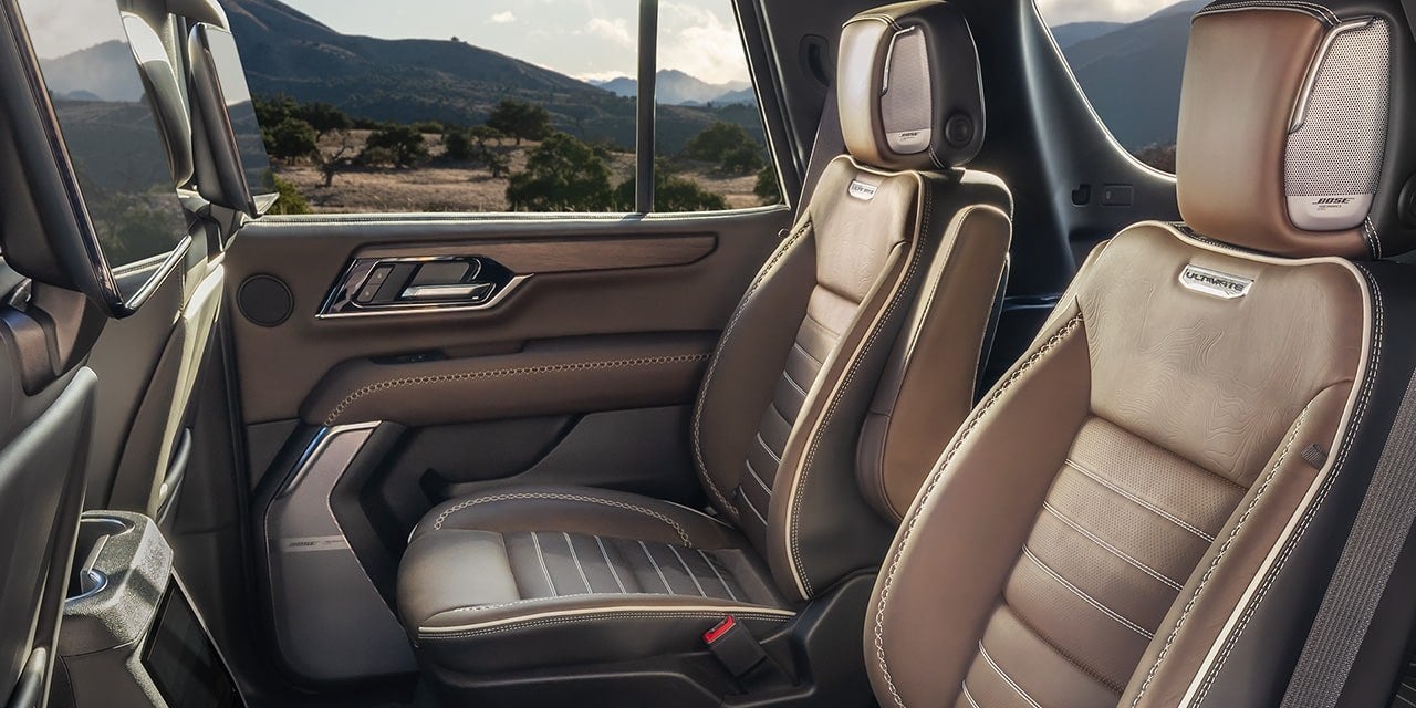 Second row seating inside a GMC Yukon with room for passengers on a family trip