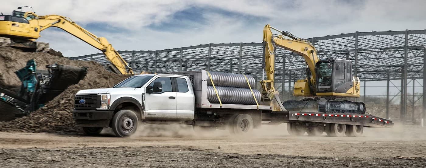 A white 2026 Ford F-350 towing a trailer.