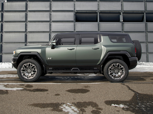 Side view of the 2024 GMC Hummer EV SUV in green parked on pavement