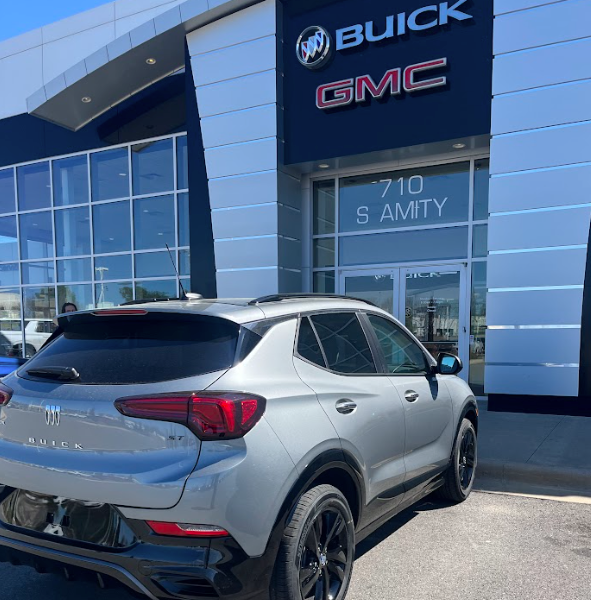 Silver Buick SUV parked in front of Crain Buick GMC in Conway, Arkansas, with dealership signage visible