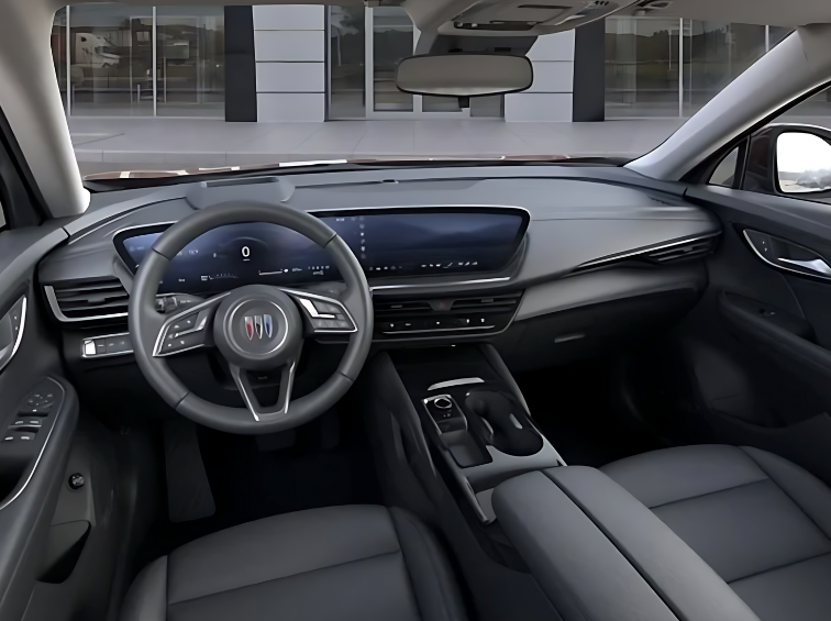 Wide view of the 2025 Buick Envision interior with a curved digital display, leather seats, and premium console layout