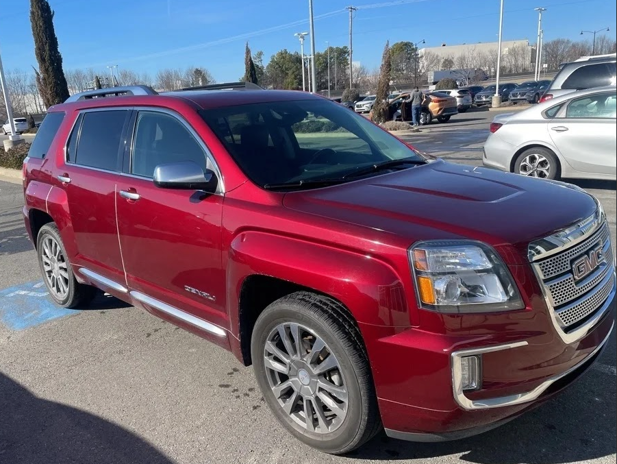 Pre-owned red GMC Terrain SUV parked at Crain Buick GMC in Conway, Arkansas