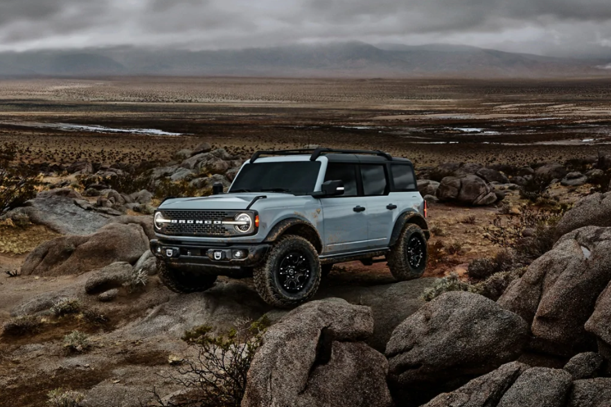 Sky Blue new Ford Bronco on top of rocky mountain