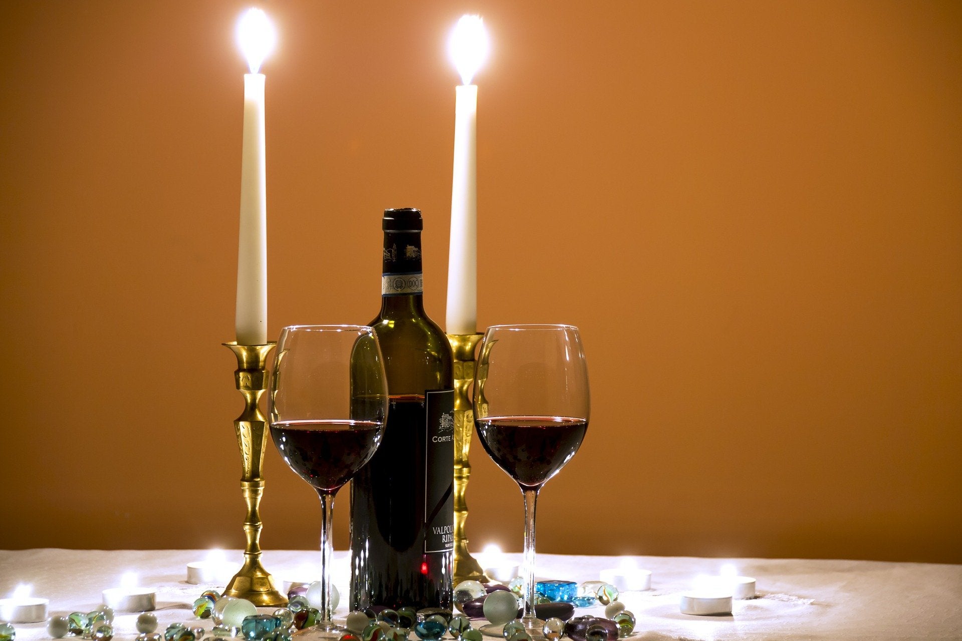 wine glasses and candles set on table