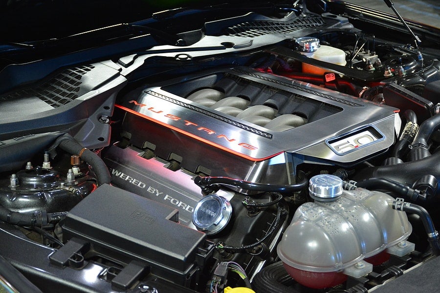 Engine underneath the hood of a car