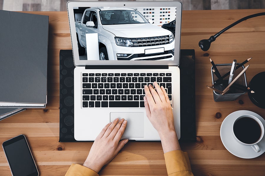 Buying Online. Woman Choosing Car Using Laptop, Top View