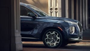 Front view of a dark blue 2022 Hyundai Palisade parked in between two columns. | Hyundai dealer in Fort Smith, AR.