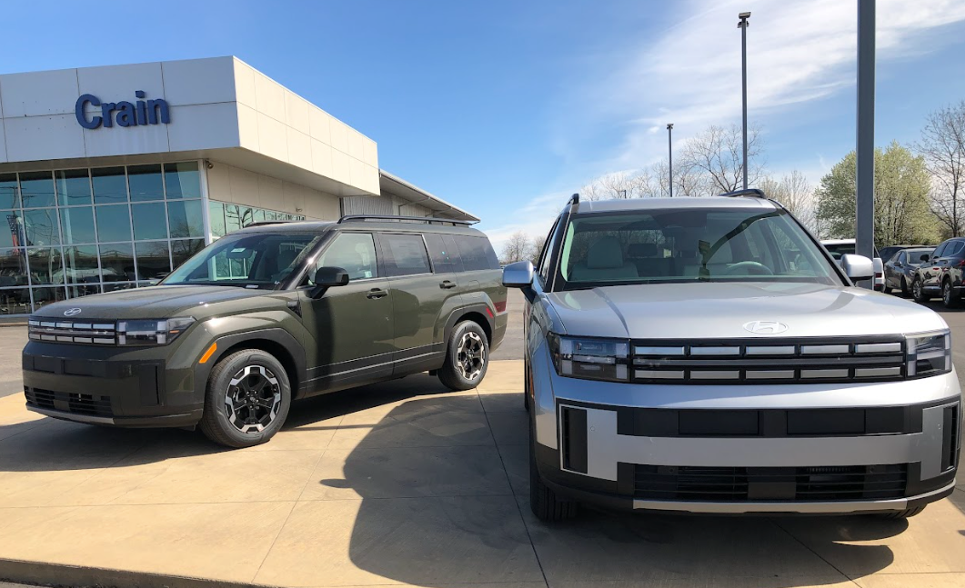 Two 2024 Hyundai Santa Fe SUVs parked outside Crain Hyundai of Fort Smith