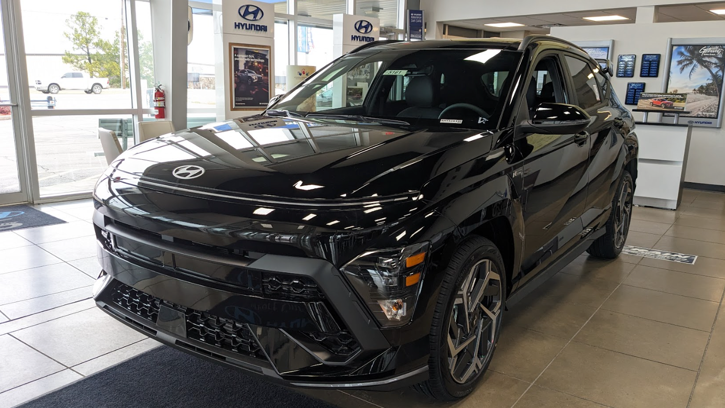 Black Hyundai SUV parked inside showroom at Crain Hyundai of Fort Smith