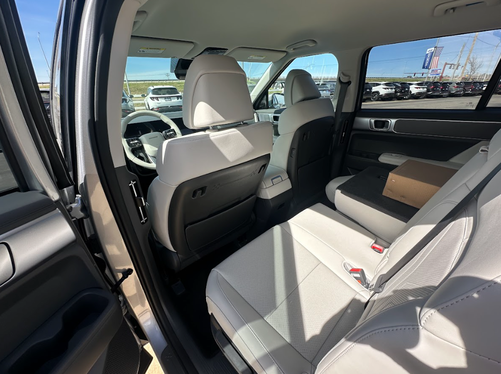 Rear seating area of a Hyundai SUV with light upholstery and folded seats, highlighting family-friendly interior space.