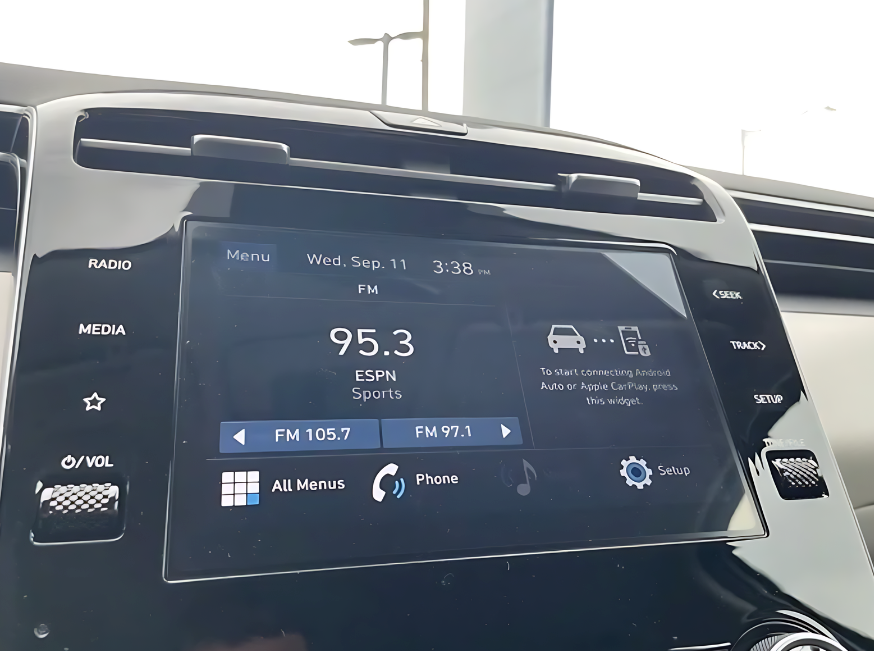 Close-up of a Hyundai infotainment touchscreen showing FM radio station 95.3 ESPN Sports with media and connectivity options.