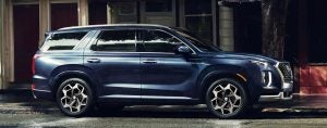 A dark blue 2022 Hyundai Palisade parked in front of a building. | Hyundai service in Fort Smith, AR.