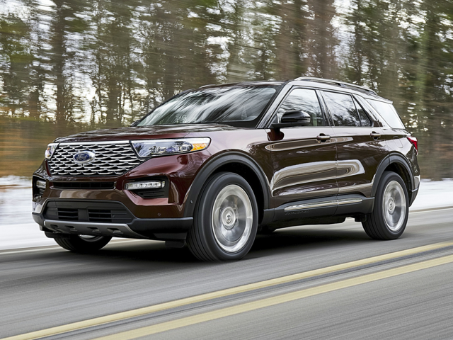 A maroon 2024 Ford Explorer driving down a Michigan road in the winter time