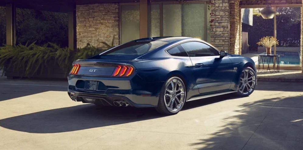 Dark blue 2022 Ford Mustang parked in front of a home. | Ford dealer in Jacksonville, AR.