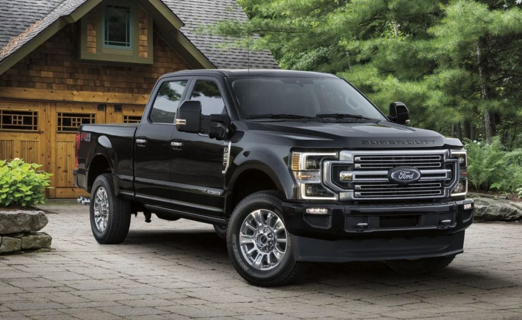 A black 2022 Ford F-250 parked in front of a brick house. | Ford dealer in Jacksonville, AR.