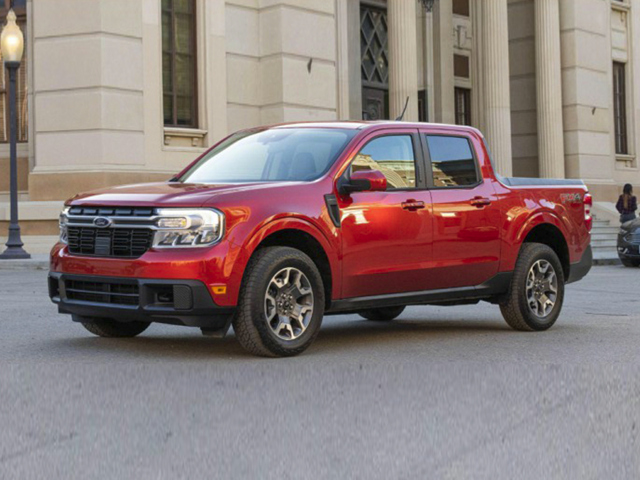 Profile view of a red 2023 Ford Maverick parked in front of a building. | Ford dealer in Little Rock, AR | Crain Ford of Little Rock