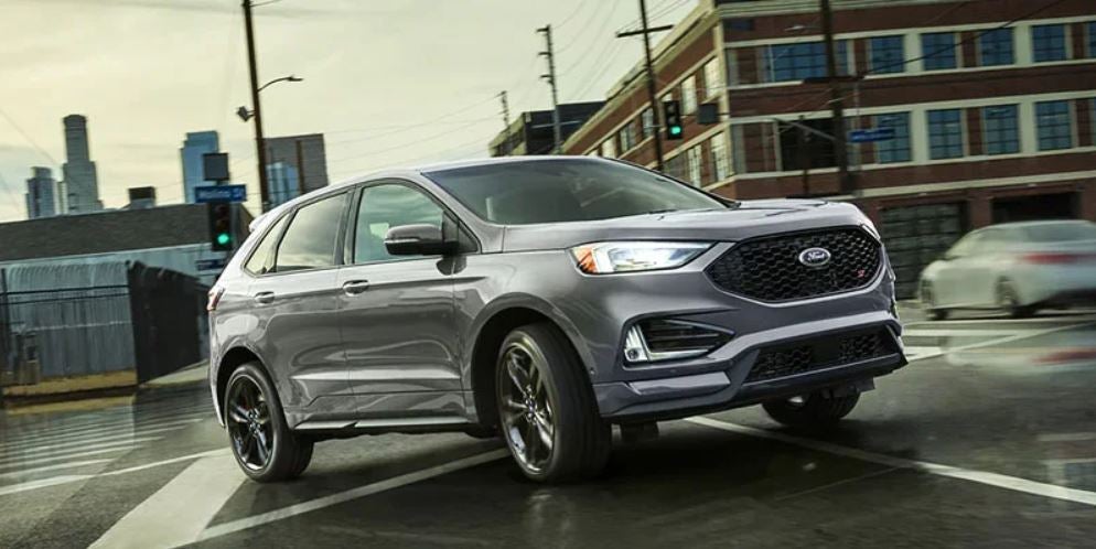 Profile view of a silver 2022 Ford Edge parked with the lights on. | Ford dealer in Little Rock, AR.