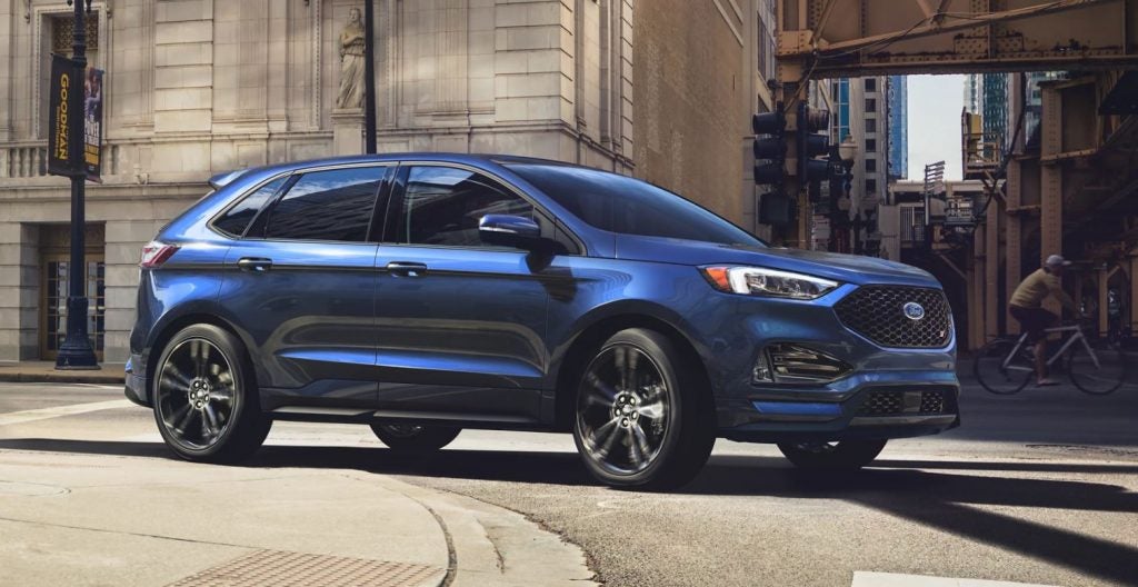 A blue 2021 Ford Edge parked on the street with a building in the background. | Ford dealer in Little Rock, AR.