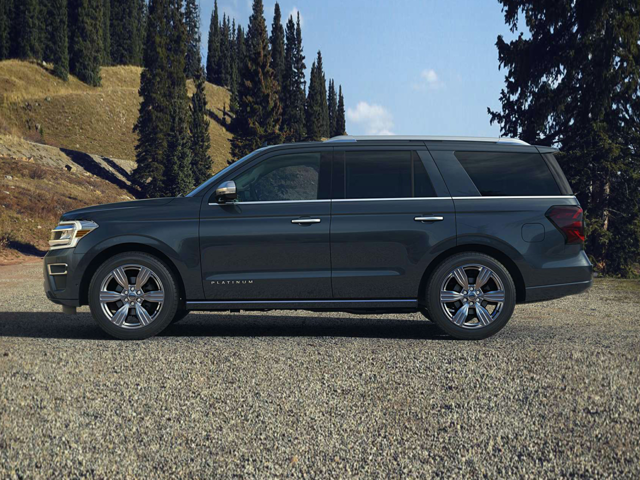 Profile view of a bluish-gray 2023 Ford Expedition parked with trees in the background. | Ford Dealer | Crain Ford of Little Rock