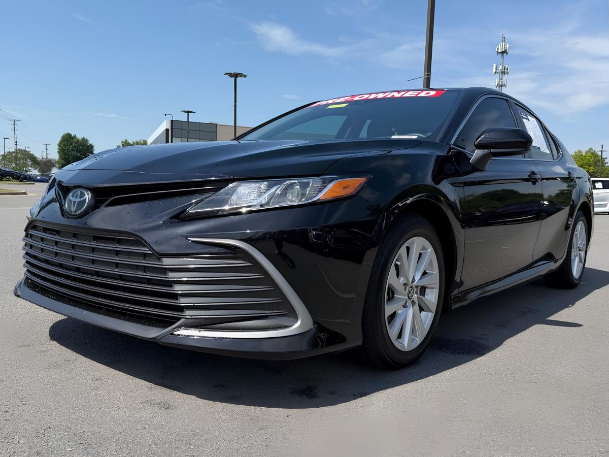 Black Toyota Camry parked at Crain Kia of Sherwood dealership