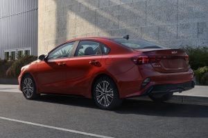 A red 2022 Kia Forte parked on the road. | Kia dealer in Sherwood, AR.