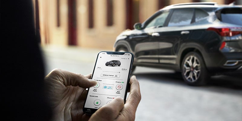Someone booking Kia Service on an app. | Kia service center in Conway, AR.
