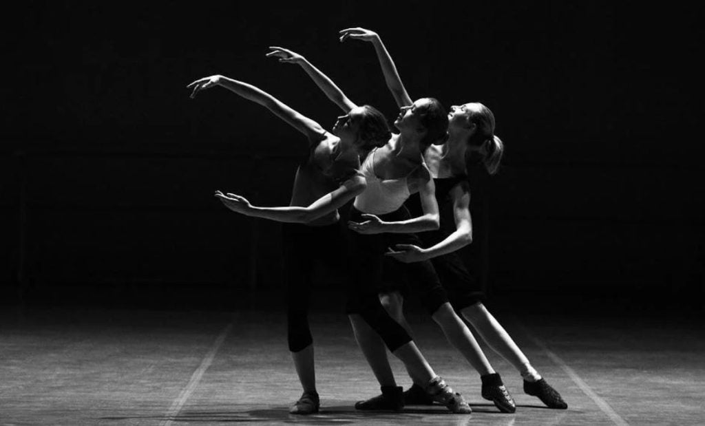 Three ballerinas posed together on a stage. | Live theatres around Conway, AR.