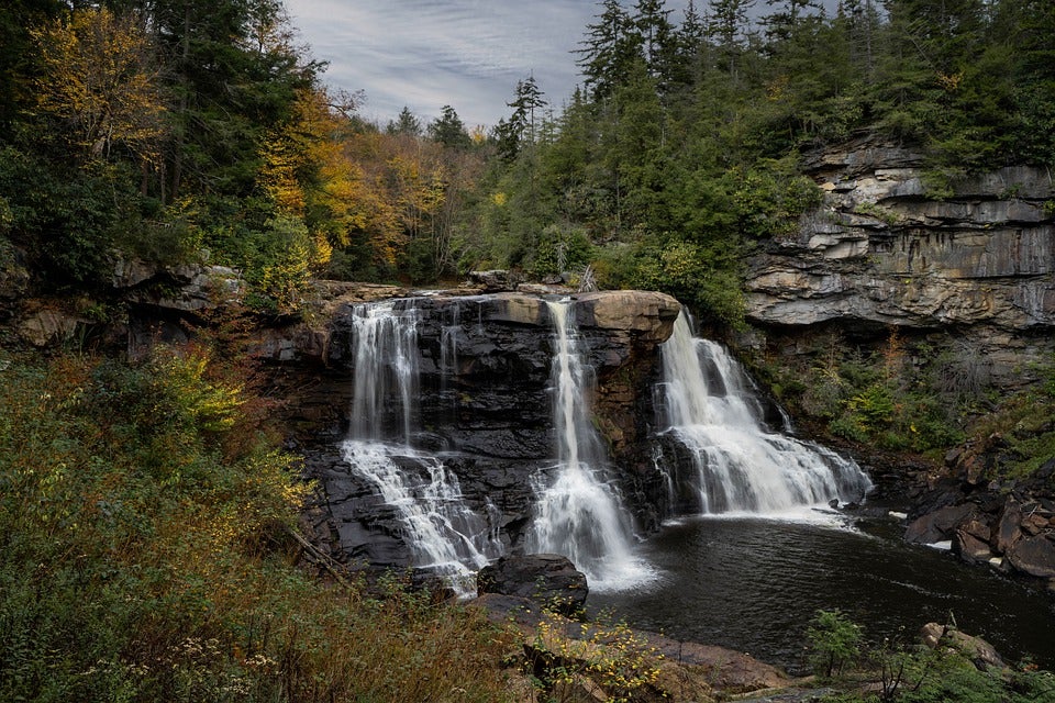 Waterfall in a heavily forested area. | State parks near Conway, AR.