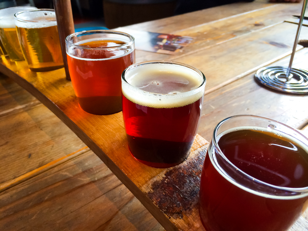 A flight of craft beers on a table. | Kia Dealer in Conway, AR.