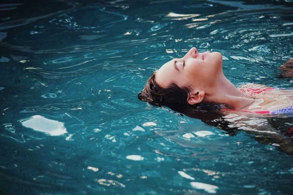 A woman floating in a pool. | Swimming near Conway, AR | Crain Kia of Conway